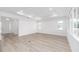 Spacious living room featuring light wood flooring, recessed lighting, and large windows at 10032 Sw 85Th Place Rd, Ocala, FL 34481