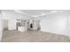 A large open-concept living room and kitchen with recessed lights and wood-style floors at 10032 Sw 85Th Place Rd, Ocala, FL 34481