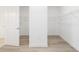 Spacious walk-in closet with wire shelving and wood-look floors at 10032 Sw 85Th Place Rd, Ocala, FL 34481