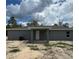 An exterior view of the back of the house with a covered porch at 10385 Se 125Th Ln, Belleview, FL 34420