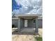Covered back porch with a white door and a small window at 10385 Se 125Th Ln, Belleview, FL 34420