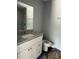 Bathroom with granite vanity, white cabinets, and modern fixtures at 10385 Se 125Th Ln, Belleview, FL 34420