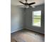 Bright bedroom featuring a ceiling fan and a window with views of the surrounding landscape at 10385 Se 125Th Ln, Belleview, FL 34420