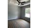 Bedroom featuring a tray ceiling, ceiling fan, window and neutral paint at 10385 Se 125Th Ln, Belleview, FL 34420