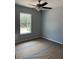 Bedroom featuring a ceiling fan, large window and neutral paint at 10385 Se 125Th Ln, Belleview, FL 34420
