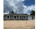 Charming one-story home with a gray exterior, white trim, and a well-manicured lawn at 10385 Se 125Th Ln, Belleview, FL 34420