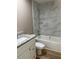 Bright bathroom features modern marble tile, a tub with shower, and a granite countertop at 10401 Se 125Th Ln, Belleview, FL 34420
