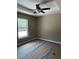 Neutral bedroom featuring ceiling fan and ample natural light at 10401 Se 125Th Ln, Belleview, FL 34420