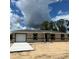 New construction shows a single story home with an attached garage and a modern design at 10401 Se 125Th Ln, Belleview, FL 34420