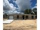 New construction shows a single story home with an attached garage and a modern design at 10401 Se 125Th Ln, Belleview, FL 34420