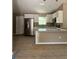 New kitchen features white cabinets, granite countertops, and stainless steel appliances at 10401 Se 125Th Ln, Belleview, FL 34420