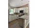New kitchen features white cabinets, granite countertops, and stainless steel appliances at 10401 Se 125Th Ln, Belleview, FL 34420