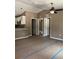 Open-concept living area with kitchen view and two door bedroom access at 10401 Se 125Th Ln, Belleview, FL 34420