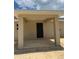View of the covered back porch with a modern door leading to the backyard at 10401 Se 125Th Ln, Belleview, FL 34420