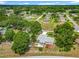 An aerial view of the backyard showing the wooden deck, screened patio and a fenced yard at 10459 Sw 62Nd Ct, Ocala, FL 34476