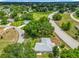 An aerial view of the home with a large wooden deck, a screened patio, and mature landscaping in a quiet neighborhood at 10459 Sw 62Nd Ct, Ocala, FL 34476
