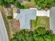 An aerial view of the home with a large wooden deck, a screened patio, and mature landscaping at 10459 Sw 62Nd Ct, Ocala, FL 34476
