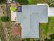 An aerial view of the home with a large wooden deck, a screened patio, and mature landscaping at 10459 Sw 62Nd Ct, Ocala, FL 34476