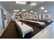 Community ballroom with rows of tables and chairs for event seating, bright lighting, and neutral decor at 10459 Sw 62Nd Ct, Ocala, FL 34476