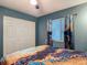 Inviting bedroom with a window view, closet, and bright curtains at 10459 Sw 62Nd Ct, Ocala, FL 34476