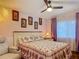Cozy bedroom with floral bedding, window with lavender curtains, and recliner at 10459 Sw 62Nd Ct, Ocala, FL 34476