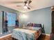 Comfortable bedroom featuring a ceiling fan, large window, and unique curtains at 10459 Sw 62Nd Ct, Ocala, FL 34476