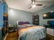 Well-lit bedroom with a large window, desk, and sleek shelving unit at 10459 Sw 62Nd Ct, Ocala, FL 34476