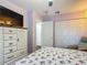 Bright bedroom with closet, television, dresser, and calming decor at 10459 Sw 62Nd Ct, Ocala, FL 34476