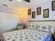Cozy bedroom with floral bedding, a sitting chair, and decorative wall art at 10459 Sw 62Nd Ct, Ocala, FL 34476