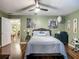 Bedroom with neutral walls, a ceiling fan, artwork, and wood-look flooring at 10459 Sw 62Nd Ct, Ocala, FL 34476