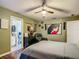Bedroom with neutral walls, art, reading chair, and view into Primary bathroom at 10459 Sw 62Nd Ct, Ocala, FL 34476