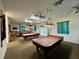 Spacious billiard room featuring multiple pool tables, ceiling fans, and ample lighting for recreational enjoyment at 10459 Sw 62Nd Ct, Ocala, FL 34476
