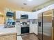 The bright kitchen features white cabinets, stainless steel appliances, and modern countertops at 10459 Sw 62Nd Ct, Ocala, FL 34476