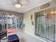 Enclosed lanai featuring tile flooring and access to an outdoor patio; perfect for relaxing and entertaining at 10459 Sw 62Nd Ct, Ocala, FL 34476