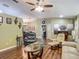 A living room includes hardwood floors, and views of the dining room, kitchen, and front door at 10459 Sw 62Nd Ct, Ocala, FL 34476