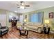 This cozy living room features hardwood floors, bright natural light, and comfortable seating at 10459 Sw 62Nd Ct, Ocala, FL 34476