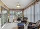 Enclosed sunroom with tile floor, ceiling fan and large sliding glass doors to lanai for enhanced indoor/outdoor living at 10459 Sw 62Nd Ct, Ocala, FL 34476