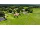 Aerial view shows the home's expansive lot, the neighborhood and its proximity to green pastures at 12131 Ne 10Th Ter, Ocala, FL 34479