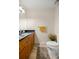 Bathroom with wood cabinets, granite countertop, decorative flowers, and a tile floor at 12131 Ne 10Th Ter, Ocala, FL 34479
