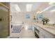 Bright bathroom with a soaking tub, double sinks, and skylights for natural illumination at 12131 Ne 10Th Ter, Ocala, FL 34479