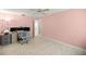 Bright bedroom with desk, monitors, and pink walls at 12131 Ne 10Th Ter, Ocala, FL 34479