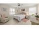 Bright bedroom featuring a wicker headboard bed, ceiling fan, and natural light at 12131 Ne 10Th Ter, Ocala, FL 34479