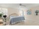 Bright bedroom with a blue bed, modern decor, and a door to the outside at 12131 Ne 10Th Ter, Ocala, FL 34479