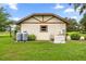 Side of house shows propane tanks, electrical boxes, and generator, surrounded by landscaping at 12131 Ne 10Th Ter, Ocala, FL 34479