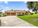Lovely home with a two-car garage, stone facade, neutral stucco, and lush green lawn at 12131 Ne 10Th Ter, Ocala, FL 34479
