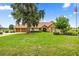 Charming home with stone facade, neutral stucco, manicured lawn, and mature landscaping at 12131 Ne 10Th Ter, Ocala, FL 34479