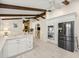 Modern kitchen featuring white cabinets, stainless appliances, sleek countertops, and wood beams at 12131 Ne 10Th Ter, Ocala, FL 34479