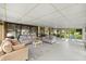 Spacious sun room with large windows, comfortable seating and scenic backyard views at 12131 Ne 10Th Ter, Ocala, FL 34479