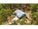 Beautiful aerial shot of a home boasting a long driveway, attached garage, and a surrounding landscape of mature trees at 12320 Sw 62Nd Pl, Ocala, FL 34481