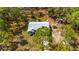 Aerial view of a well-maintained home with neutral colors and lush surrounding trees offering privacy and shade at 12320 Sw 62Nd Pl, Ocala, FL 34481